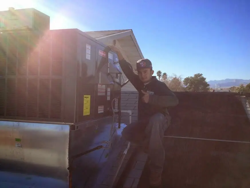 HVAC technician performing AC Tune-Up on a rooftop unit in Chartiers
